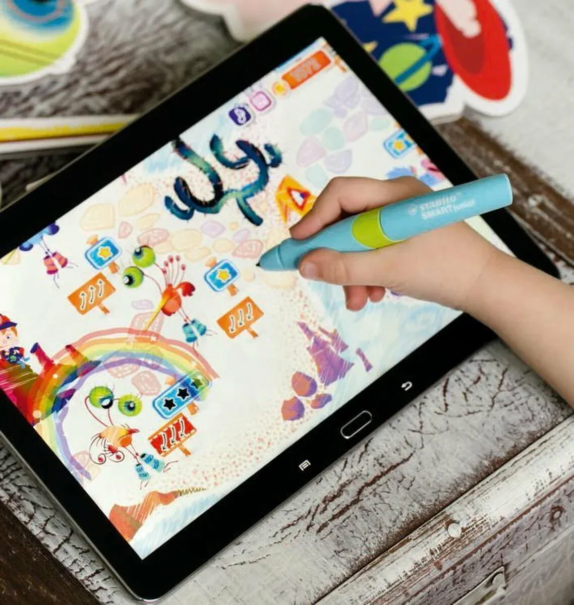 A child playing MonsterZoo on a tablet with a Stabilo SMARTjunior pen